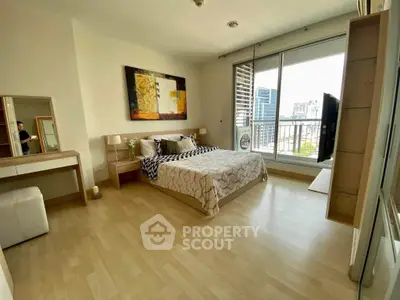 Spacious bedroom with modern decor and city view balcony access.