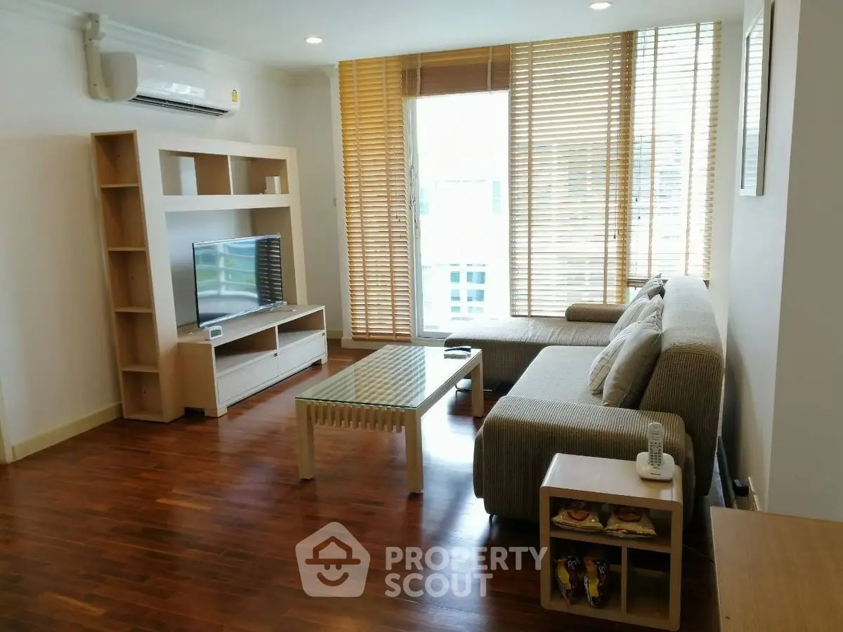 Spacious living room with modern furniture and large windows for natural light.