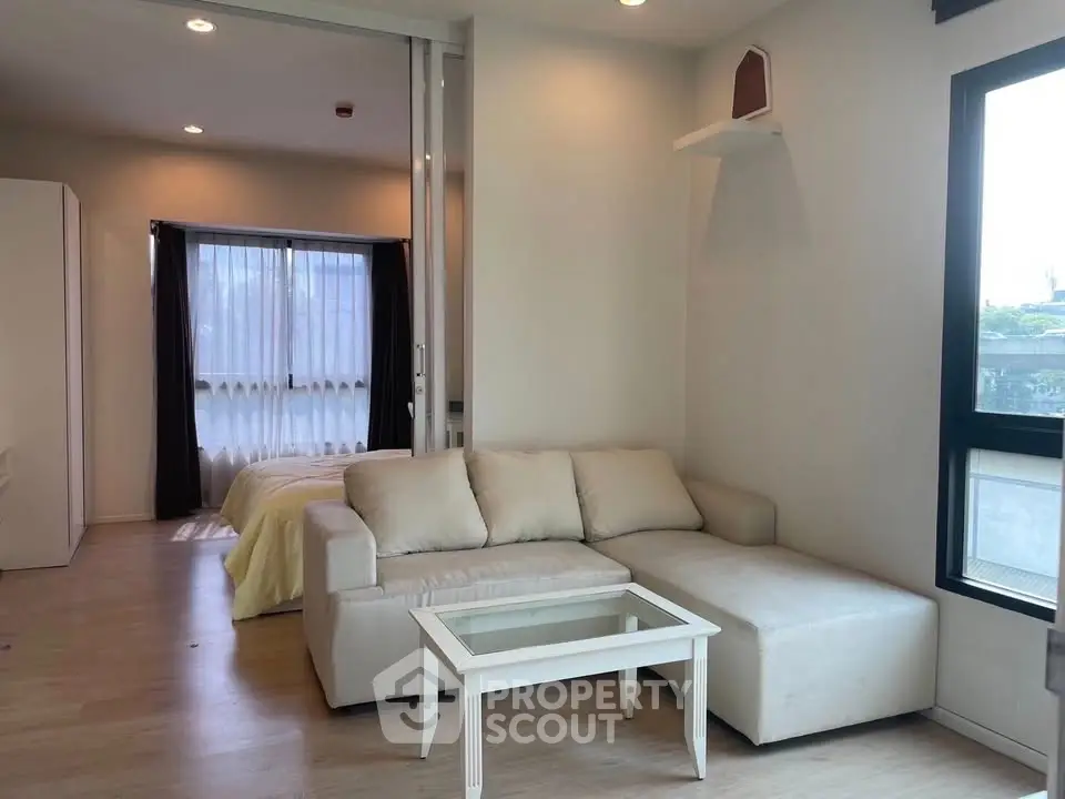 Modern living room with cozy sofa and natural light in stylish apartment