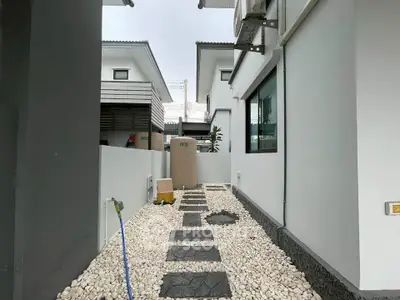 Modern residential exterior with stone pathway and sleek design