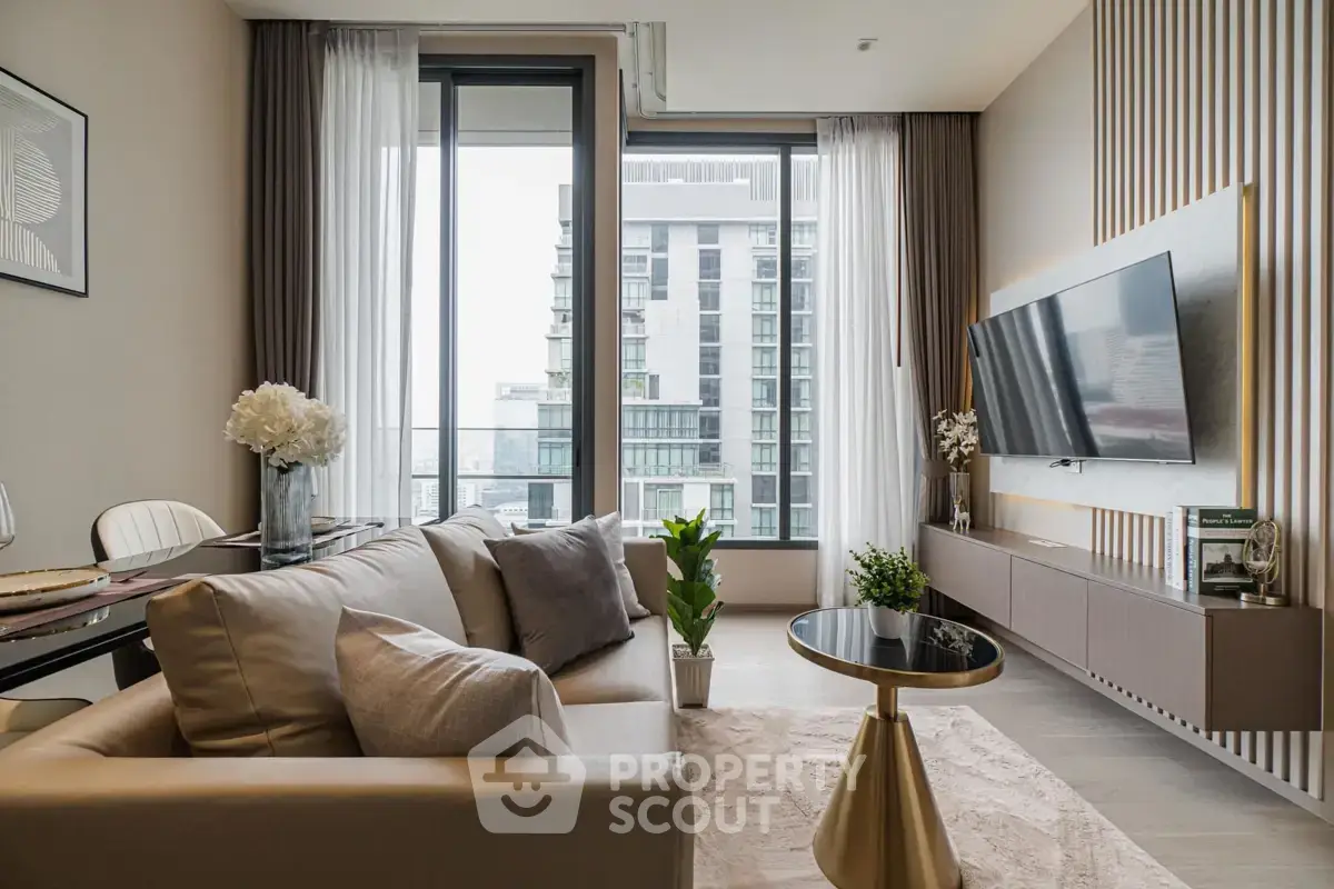 Luxurious modern living room with elegant decor and city view, featuring a sleek TV setup and stylish furniture.
