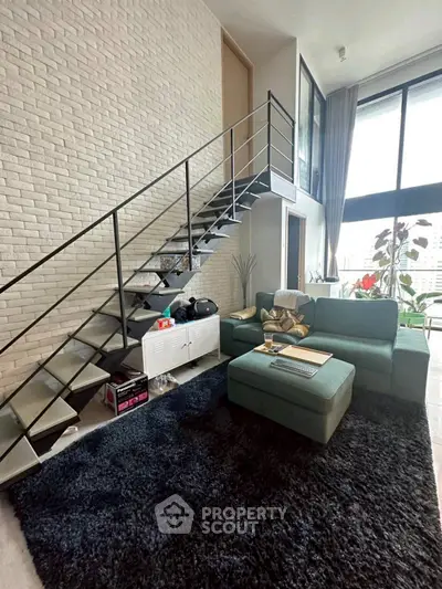 Modern loft living room with stylish staircase and cozy seating area