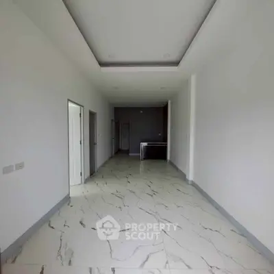 Spacious modern interior with marble flooring and recessed lighting, ideal for customization.