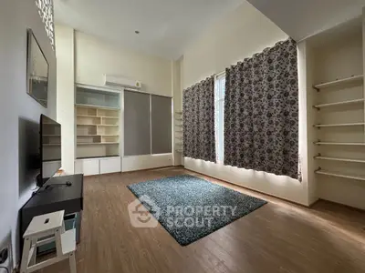 Spacious living room with modern decor and large windows