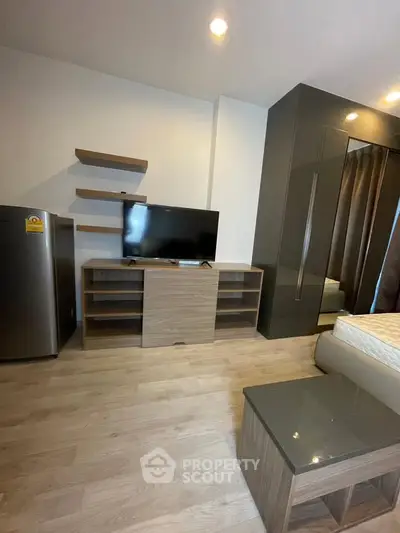 Modern bedroom with sleek furniture and built-in wardrobe