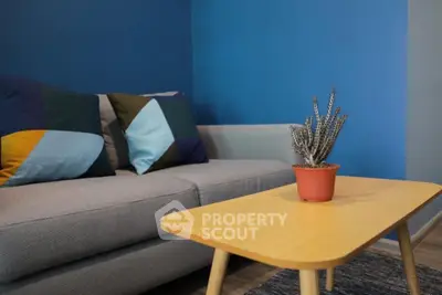 Stylish living room with modern sofa and cactus on wooden table