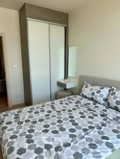 Modern bedroom with stylish geometric bedding and built-in wardrobe