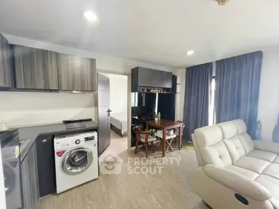 Modern living room with washing machine and cozy seating area
