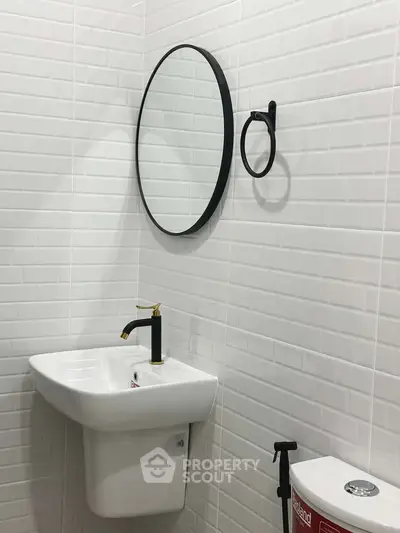 Modern bathroom with sleek white tiles and stylish fixtures