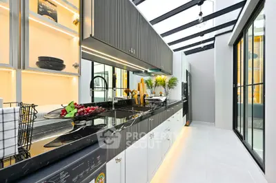 Modern kitchen with sleek black countertops and open layout design