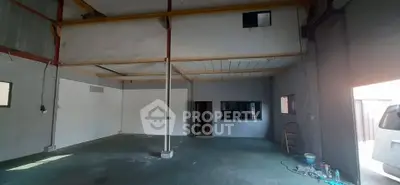 Spacious industrial warehouse with high ceilings and mezzanine level, ideal for storage or workshop use.