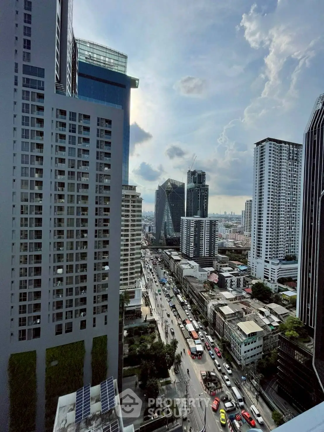 Stunning cityscape view from a high-rise building showcasing urban architecture and bustling streets.