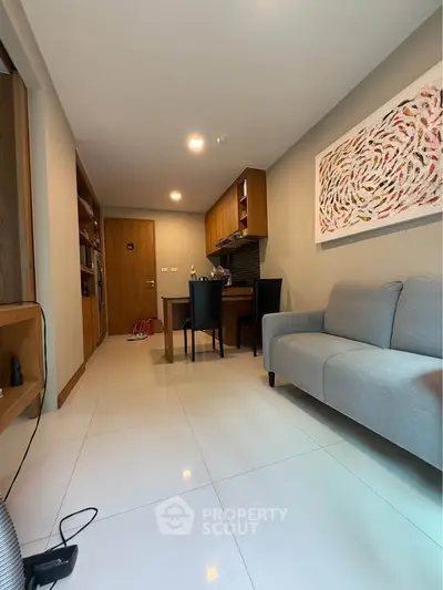 Modern living room with sleek furniture and stylish wall art in a cozy apartment.