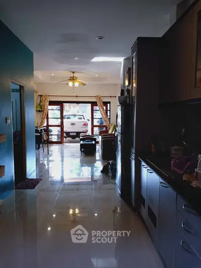 Spacious open-layout kitchen and living area with modern appliances and large windows.