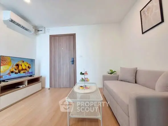 Modern living room with sleek furniture and wall-mounted TV, perfect for relaxation.