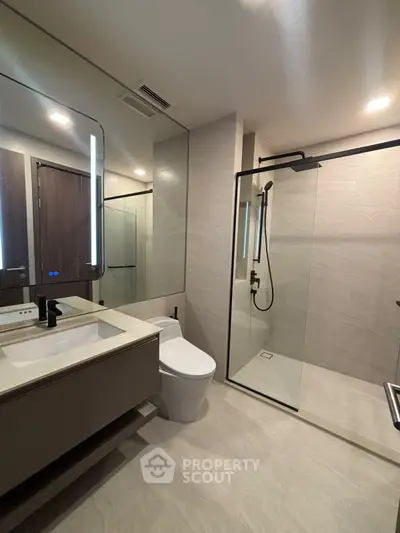 Modern bathroom with sleek glass shower and contemporary fixtures