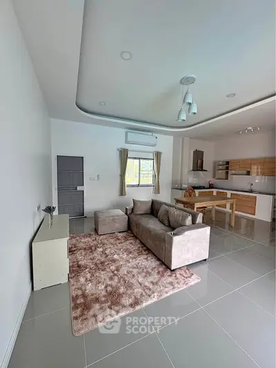 Spacious modern living room with open kitchen and stylish decor