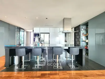Luxurious modern kitchen with sleek black island and high-end appliances, perfect for gourmet cooking.