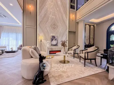 Luxurious living room with elegant decor and high ceilings, featuring modern furniture and ambient lighting.