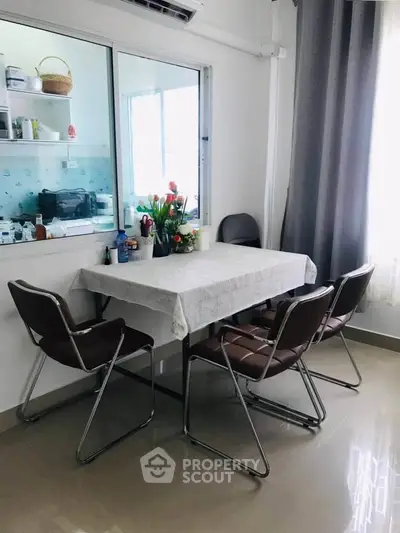 Cozy dining area with table and chairs, perfect for intimate meals.