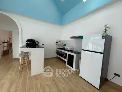 Modern kitchen with open layout and sleek appliances in bright, airy space.