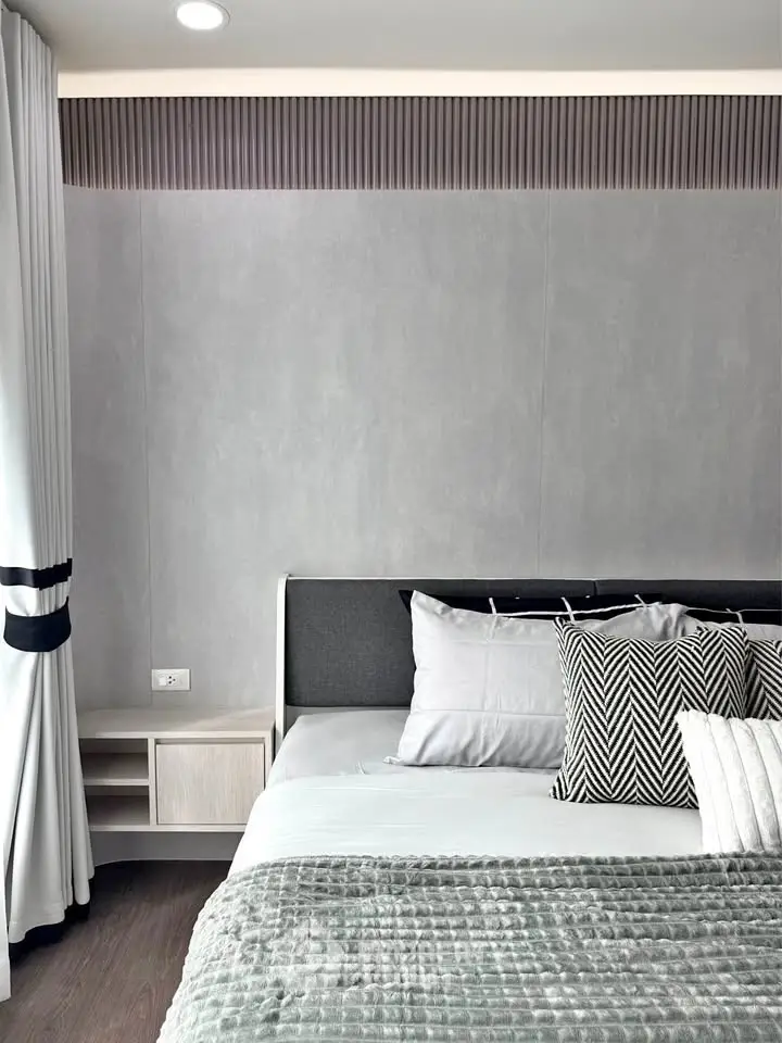 Modern bedroom with stylish decor and cozy bedding