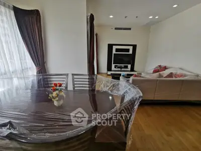Spacious living room with elegant dining area and cozy seating, perfect for relaxation and entertainment.