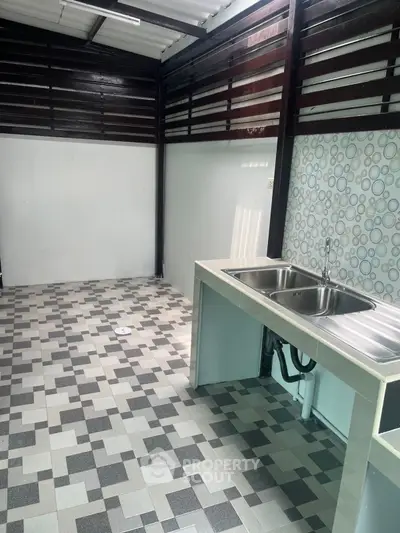 Modern kitchen with dual sink and stylish tile flooring