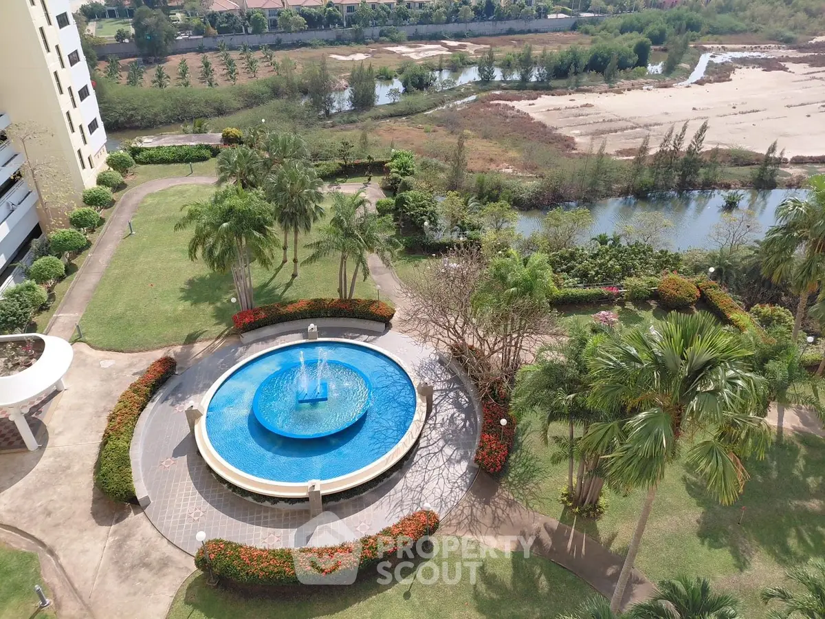 Stunning aerial view of a luxurious residential pool surrounded by lush greenery and scenic landscape.