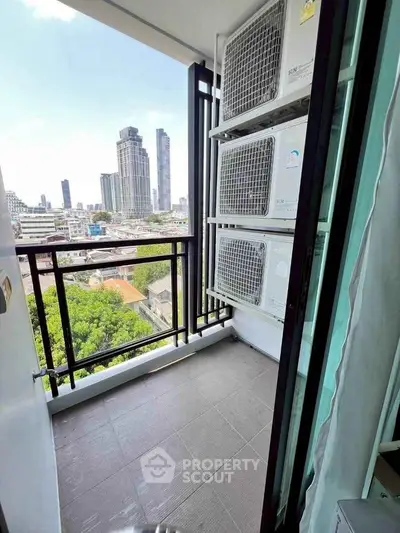 Modern balcony with city view and air conditioning units, perfect for urban living.