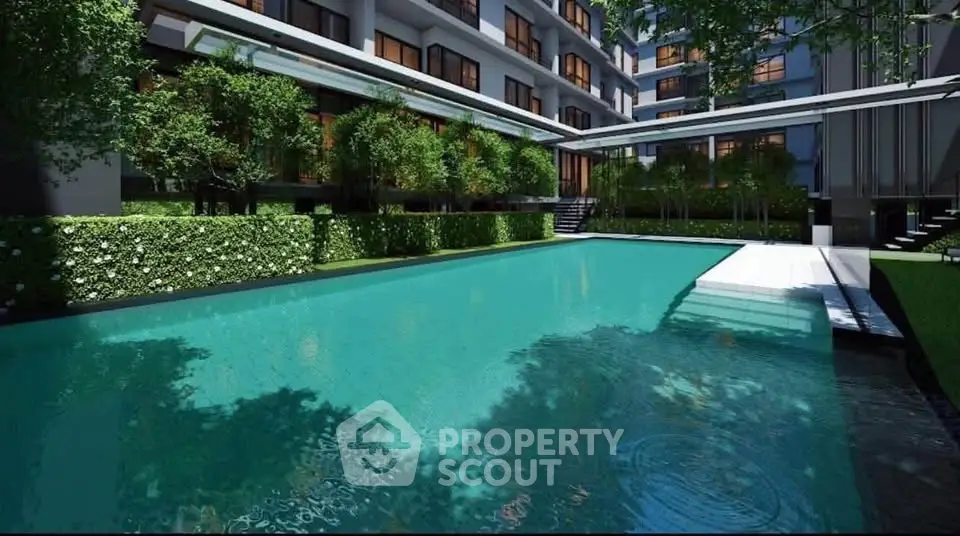 Luxurious apartment complex with a stunning outdoor pool and lush greenery.