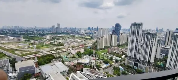Stunning cityscape view from high-rise building balcony, showcasing urban skyline and greenery.