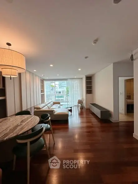 Spacious modern living room with wooden flooring and elegant furniture