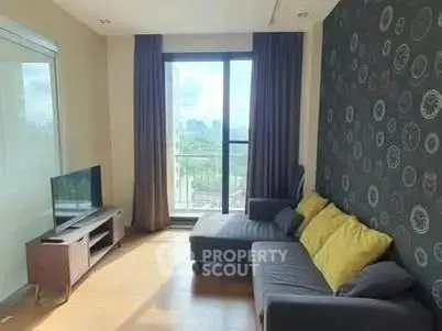 Modern living room with stylish decor and city view from large window.