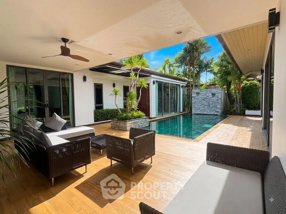 Luxurious villa with private pool and stylish outdoor seating area, perfect for relaxation and entertainment.