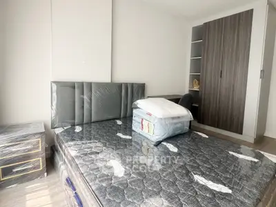 Modern bedroom with stylish wardrobe and comfortable bed in a bright apartment.