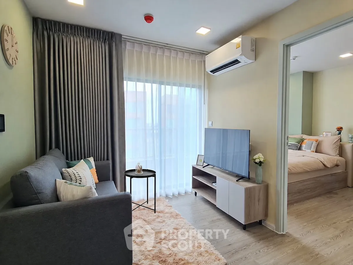 Modern living room with cozy sofa, TV, and large window in stylish apartment