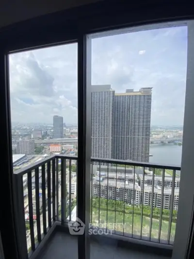 Stunning high-rise balcony view overlooking cityscape and river