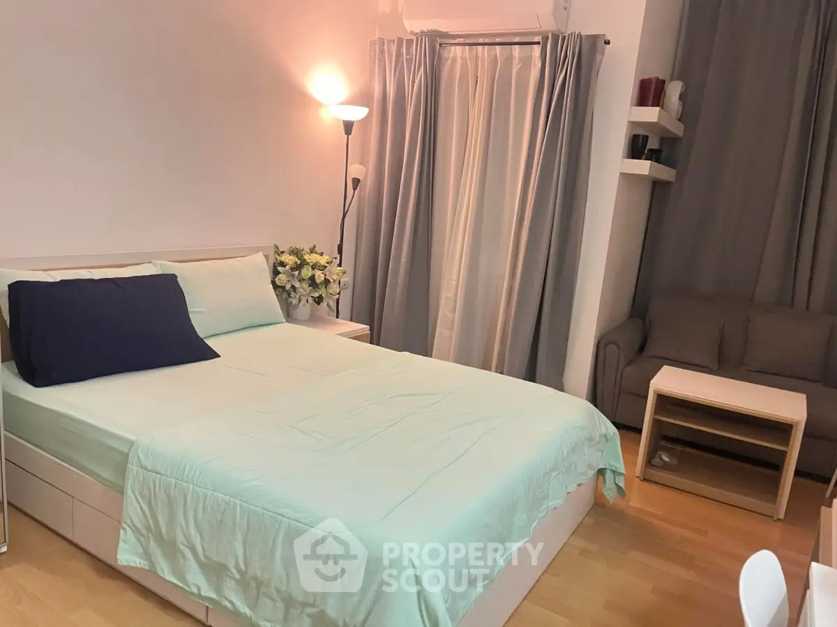 Cozy bedroom with modern decor and soft lighting, featuring a comfortable bed and stylish furnishings.