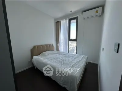 Modern bedroom with large window and air conditioning unit.