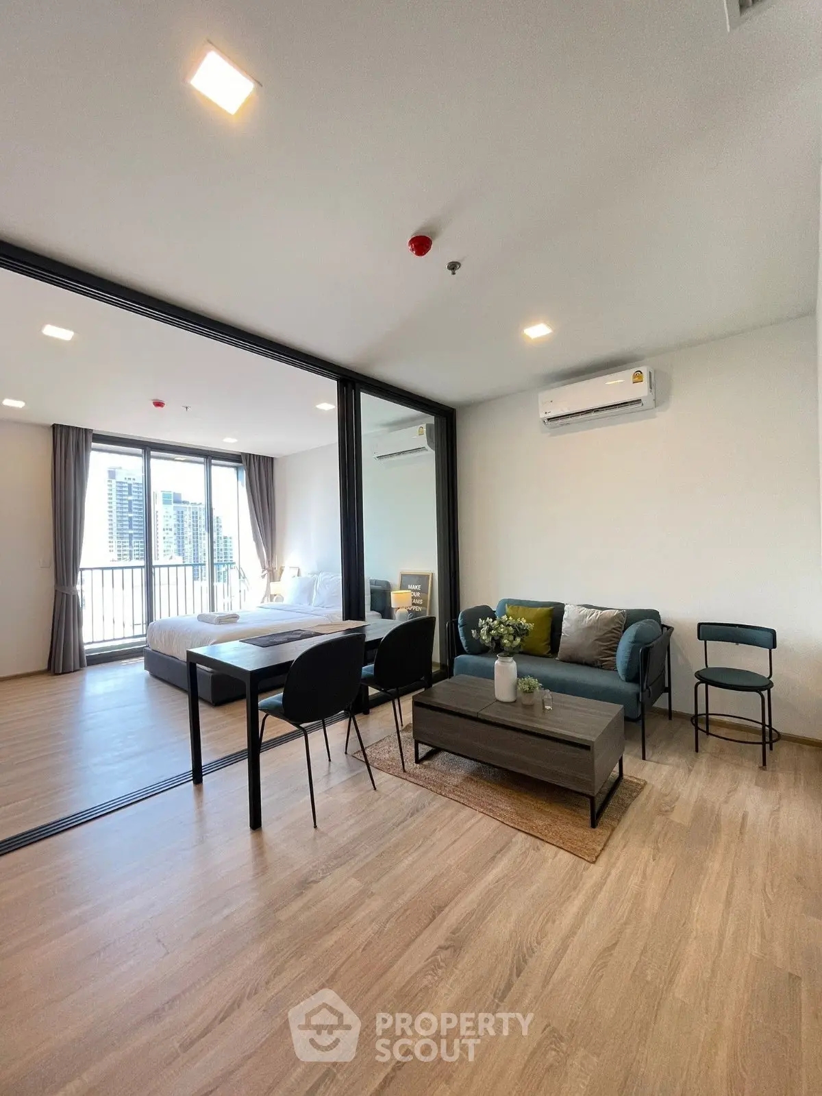 Modern open-plan living room with stylish decor and city view balcony