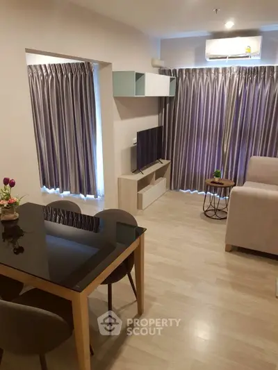 Modern living room with sleek furniture and large windows, perfect for relaxation and entertainment.