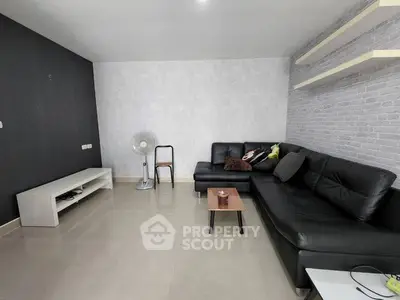 Modern living room with sleek black sofa and minimalist decor