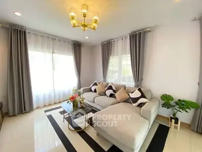 Elegant living room with stylish decor and large windows for natural light.