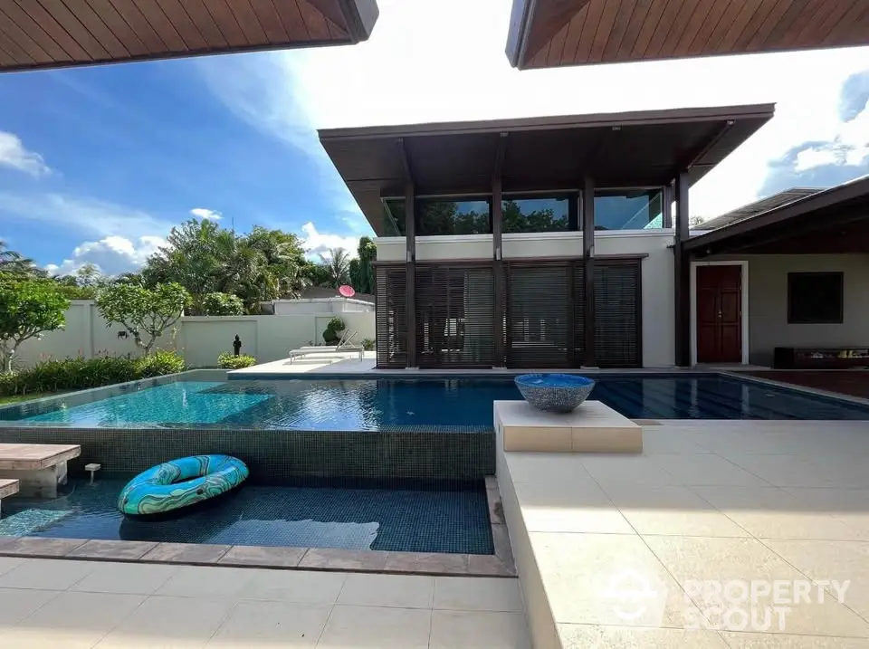 Luxurious modern villa with stunning pool and spacious outdoor area, perfect for relaxation and entertainment.