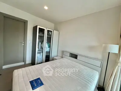 Modern bedroom with sleek furniture and ample natural light, perfect for a cozy retreat.