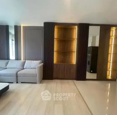 Spacious modern living room with elegant built-in shelving and cozy sofa