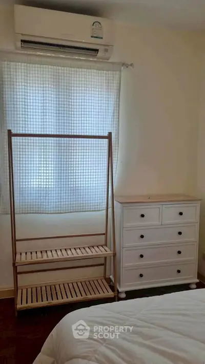 Cozy bedroom with air conditioning and minimalist furniture