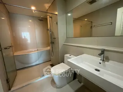 Modern bathroom with sleek fixtures and glass shower enclosure