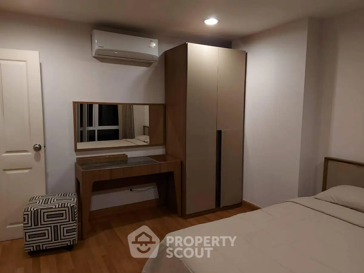 Cozy bedroom with modern furniture and air conditioning, perfect for relaxation and comfort.
